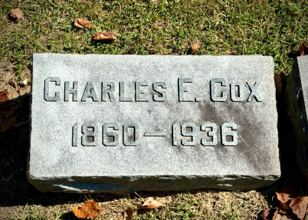 Headstone of Charles E. Cox. He was born in 1860 and died in 1936.