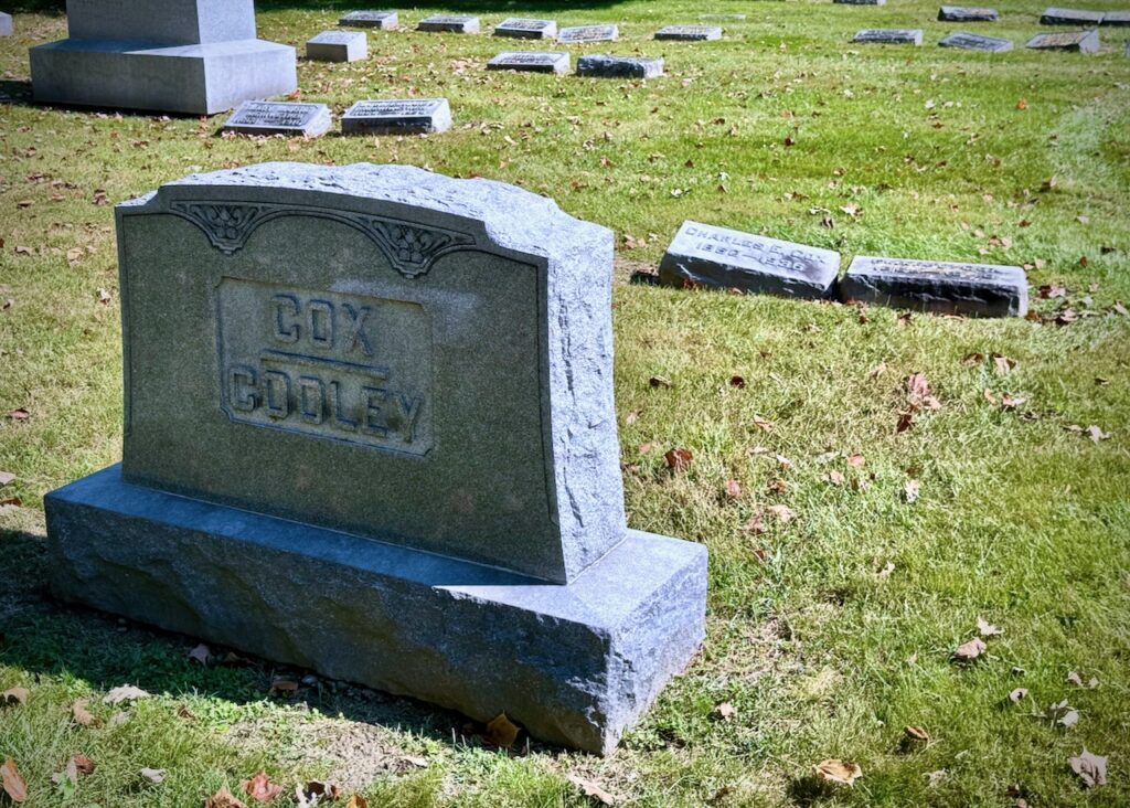 Cemetery stone for the Cox/Cooley family on the left. The two stones in the upper right are for Charles E. Cox and his wife.